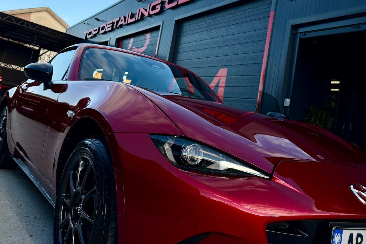 dark red car with a vinyl wrap